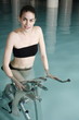 Young woman on exercise bike in spa pool