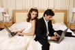 Bride and groom on laptops
