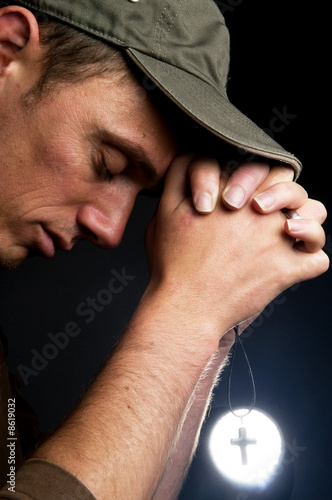 Photo: Praying Man Holding A Cross Praying Man Holding A Cross