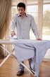 Man ironing shirt