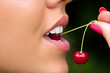Foto: Lips of the girl tasting a cherry Lips of the girl tasting a cherry