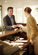Man checking in  at the hotel reception desk