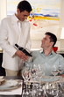 Waiter displaying wine bottle