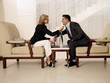 Man and woman sitting in hotel lobby