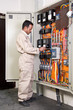 Electrician inspecting wires in electric panel