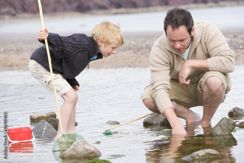 Photo: Father and son at beach fishing Father and son at beach fishing