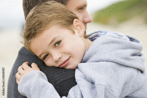 Photo: Father holding son at beach Father holding son at beach