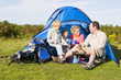 Family camping with tent and cooking