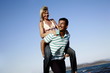 Photo: Mature adult couple piggyback on beach Mature adult couple piggyback on beach