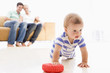 Photo: Couple in living room with baby smiling Couple in living room with baby smiling