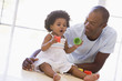 Father and daughter indoors playing and smiling