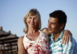 Photo: Mature adult couple sitting on beach Mature adult couple sitting on beach