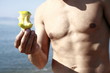 Photo: Male mature adult with apple on beach Male mature adult with apple on beach