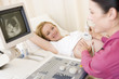 Pregnant woman getting ultrasound from doctor Pregnant woman getting ultrasound from doctor
