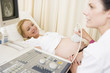 Pregnant woman getting ultrasound from doctor