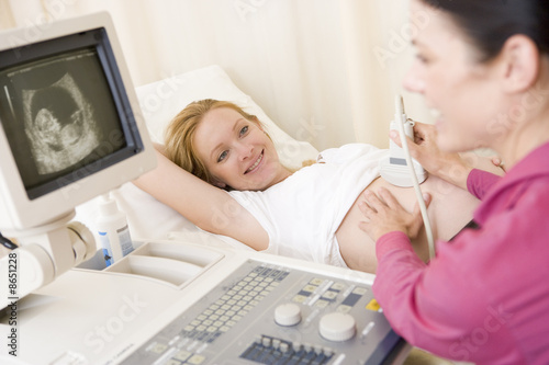Photo: Pregnant woman getting ultrasound from doctor Pregnant woman getting ultrasound from doctor