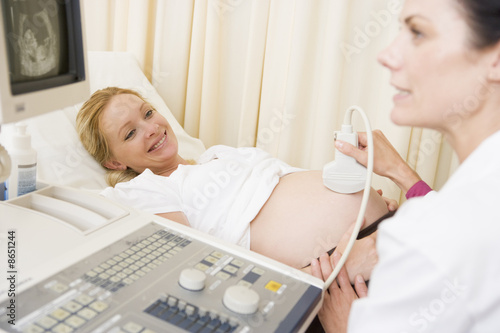 Photo: Pregnant woman getting ultrasound from doctor Pregnant woman getting ultrasound from doctor