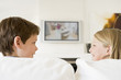Photo: Young boy and young girl in living room with flat screen televis Young boy and young girl in living room with flat screen televis