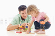 Photo: Father and daughter indoors playing and smiling Father and daughter indoors playing and smiling