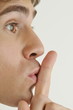 "Young male adult;finger to lips"