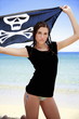 Young woman in bikini holding up skull and bones flag