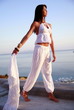 Woman in white outfit on terrace with a view