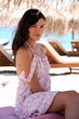 Young woman on chaise lounge on beach