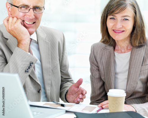 Portrait of business colleagues sitting together with documents Portrait of business colleagues sitting together with documents