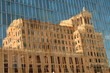 An old building reflected in a new one