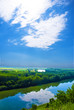 Reflection of beautiful white clouds in river with forest