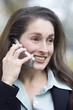 Close up of a smiling business woman talking on the phone.