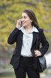 Photo: View of a business woman talking on the phone and smiling. View of a business woman talking on the phone and smiling.