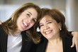 Photo: Portrait of two smiling women. Portrait of two smiling women.