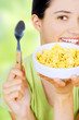 young woman eating cornflaks