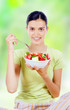 young beautiful woman eating healthy food - salad