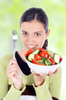 young beautiful woman eating healthy food - salad
