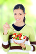 young beautiful woman eating healthy food - salad