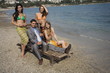 Businessman on beach with three women