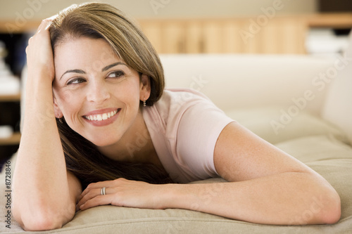Photo: Woman lying in living room Woman lying in living room