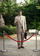 Businessman in garden behind barrier
