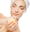 Beautiful young woman with aroma bath ball isolated on white bac