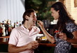 Woman feeding man in a bar