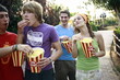Teenagers hanging out eating popcorn