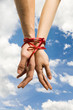 hands tieing with ribbon