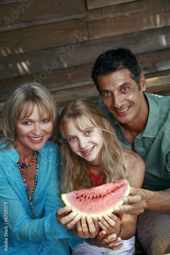 Photo: Parents with daughter and watermelon Parents with daughter and watermelon