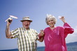 Photo: Senior couple on beach with badminton racquet and ball Senior couple on beach with badminton racquet and ball