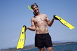 Male mature adult with swim flippers and scuba mask