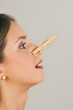 Female young adult with clothes pin on nose