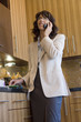 Portrait of woman on cell phone in kitchen