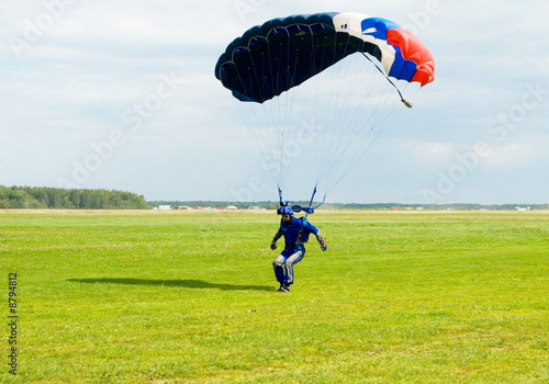 Photo: Landing of the sportsman after parachute jump Landing of the sportsman after parachute jump